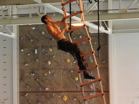 A U.S. Navy SEAL (Sea, Air and Land) candidate navigates a rope ladder at a Naval Special Warfare elevated obstacle course, SEAL candidates use the obstacle course in preparation for attending the Basic Underwater Demolition/SEAL (BUD/S) course.