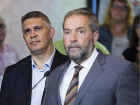 NDP Leader Tom Mulcair, right, announces during a press conference that former Saskatchewan finance minister Andrew Thomson, right, will run as an NDP candidate in the Toronto riding of Eglinton-Lawrence against Conservative incumbent Joe Oliver in Toronto on Friday, August 14, 2015.