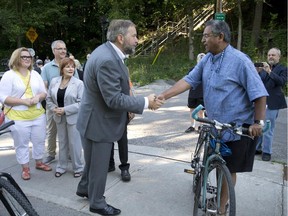 NDP leader Tom Mulcair shakes hands with a supporter near the Blackfriars Bridge during a stop in London, Ont. just before the election began. Ontario has been a very popular draw for the federal leaders.