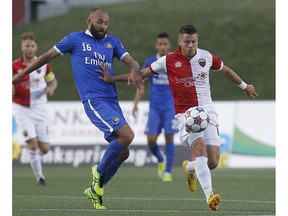 New York Cosmos' Adam Moffat (16) is kept from getting to the ball by Ottawa Fury's Carl Haworth (17) during Wednesday's 0-0 draw.