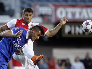 New York Cosmos' Leonardo Fernandes (22) nearly eats the boot of Ottawa Fury's Rafael Alves (33).