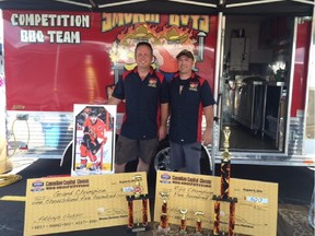 Brothers Kevin and Greg Lundy are the backbone of the competition barbecue team Smokin Boys and Hot Grills. They are shown with their winnings at Sunday's inaugural Fatboys Canadian Capital Classic BBQ Competition held outside the Canadian Tire Centre.