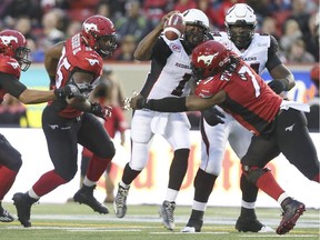 The Ottawa Redblacks' Henry Burris is sacked by Junior Turner with another Stampeder, Freddie Bishop III (95), also closing in on Saturday, Aug. 15, 2015 in Calgary. Burris was sacked three times but that was far from the only problem for Ottawa.