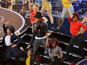 Pharrell Williams, center, performs "Happy" during the Oscars at the Dolby Theatre on Sunday, March 2, 2014, in Los Angeles.