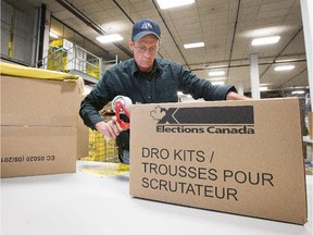 Phil Newton fills boxes with polling kits as  part of Elections Canada preparations for the federal election, last November.