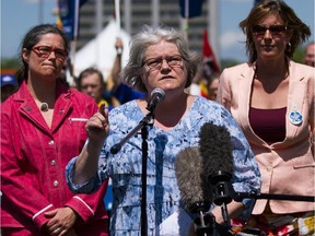 PSAC President Robyn Benson (centre) speaks at a recent rally in Ottawa.