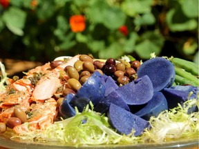 Purple potatoes, crunchy fried capers and cedar-planked salmon are colourful twists on the classic Niçoise salad.