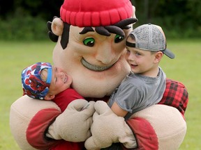 Redblacks mascot Big Joe gets a squeal from Noah, 5, and a big hug from Miller, 4, in August.