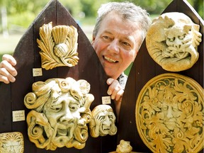 Sculptor and stone artist Douglas MacDonald smiles between his cast stone sculptures on display at Art in Strathcona Park  on Saturday, Aug. 8, 2015.