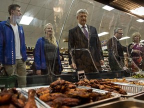 Conservative leader Stephen Harper does some grocery shopping with his son Ben and daughter Rachel at a grocery store Tuesday, August 4, 2015 in Toronto. To the right is Finance Minister Joe Oliver and Laureen Harper.