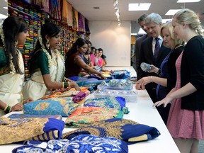 Prime Minister Stephen Harper and Ben accompany Rachel and Laureen as they shop at Asiyans clothing and gift shop in Scarborough, Ontario, Monday.
