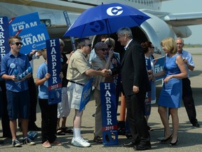 Conservative Leader Stephen Harper and and his wife Laureen are given a send off by supporters as he departs Regina, Sask., on Thursday, August 13, 2015.