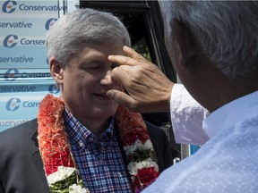 Conservative leader Stephen Harper gets a traditional Hindu welcome during a campaign stop Friday in Richmond Hill, Ont.