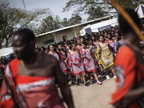 Swazi girls dance and sing as they walk to the Royal palace two day ahead of the traditional reed dance on August 28, 2015 on a farm in the outskirts of Luve, Swaziland. Umhlanga, or Reed Dance ceremony, is an annual Swazi cultural event where tens of thousands of Swazi girls travel from the various chiefdoms to the Ludzidzini Royal Village to participate in the eight-day event.