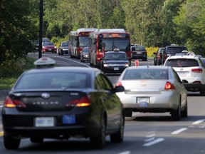 Taxi drivers drive their cabs slowly in a convoy to create traffic jams north and southbound along the Airport Parkway this afternoon in Ottawa, Monday, August 17, 2015. A fee increase for all fare pick-ups at the airport has created a tense situation between the cabbies, their union and their dispatch service. Labour action continues. Mike Carroccetto / Ottawa Citizen