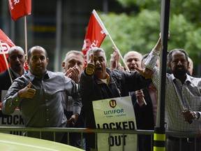 Cabbies protest at the Ottawa airport on Wednesday, Aug. 12, 2015. The Airport Taxi drivers were barred from the cab lane at the arrivals level after they refused to pay new fees under a contract between their dispatcher, Coventry Connections, and the airport authority.