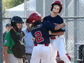 The Braves' Brady Cerkownyk (2) celebrates with his teammate after hitting a home run. Nepean catcher Tristan Godmaire couldn't hide his disappointment .