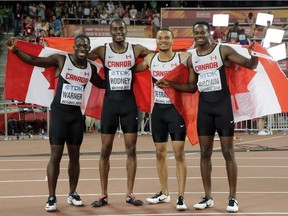The Canadian team celebrate after winning the bronze medal in the men's 4x100m relay at the World Athletics Championships at the Bird's Nest stadium in Beijing, Saturday, Aug. 29, 2015.