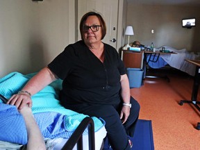 Health services manager Marg Smeaton sits with a long-term patient in the newly expanded Diane Morrison Hospice at the Ottawa Mission.