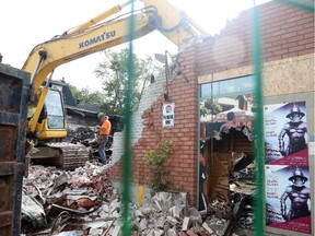 The teardown of the fire damaged building on Bank Street and Fifth Avenue began Tuesday Aug. 25, 2015.