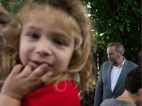 Ere Dolgin, 2, looks on as NDP Leader Tom Mulcair leaves after a campaign stop in Vancouver, B.C., on Thursday, August 20, 2015. A federal election will be held October 19.