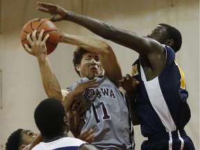 The University of Ottawa Gee-Gees' Michael L'Africain (11) wins the rebound against three Murray State Racers. The Gee-Gees played Murray State the night before the Carleton Ravens did and won by an 81-57 score.