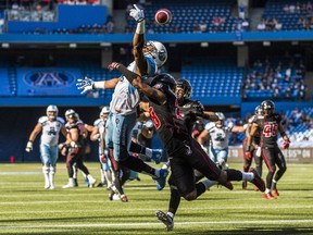 The Toronto Argonauts' Vidal Hazelton can't come down with the ball while being covered by the Ottawa Redblacks' Jacques Washington during the first half of CFL football action in Toronto on Sunday, Aug. 23, 2015.