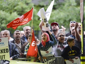 Zeinab Khazaal (11) joins her father to protest at Ottawa airport on Wednesday, Aug. 12, 2015. (James Park / Ottawa Citizen)  note: Kid on the left wearing yellow and blue checkered shirt is Hussein Khazaal (8) and kid on the right wearing batman hoody is Waleed Jabara (6)