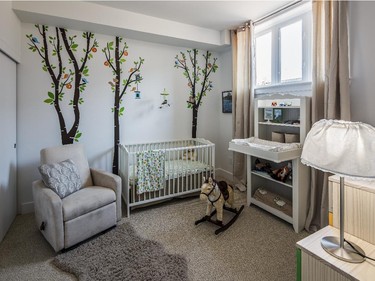 The nursery picks up a tree motif in the entryway with a trio of playful wall decals, a dozen graphic trees on a cushion and a wall art series featuring woodland creatures.