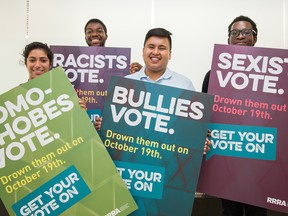 Sara Kamyav, Sylvester Nartehyoe, Graham Pedregosa, and Elton Afriyie hold signs that they will be posting up around the campus of Carleton University urging students to vote in the upcoming federal election.