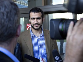 Media speak with Omar Khadr after his bail conditions hearing in Edmonton on Friday, September 11, 2015. THE CANADIAN PRESS/Jason Franson