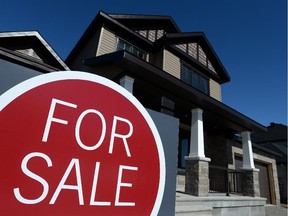 A sign advertises a new home for sale in Carleton Place, Ont. on Tuesday, March 17, 2015. The housing sector is one area of the economy that's doing well, but that might not be sustainable.