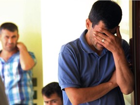 Abdullah Kurdi, 40, father of Syrian boys Aylan, 3, and Galip, 5, who were washed up drowned on a beach near Turkish resort of Bodrum on Wednesday, cries as he waits for the delivery of their bodies outside a morgue in Mugla, Turkey, Thursday, Sept. 3, 2015.(AP Photo/Mehmet Can Meral)
