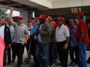 Supporting cab drivers congratulate one of three drivers arrested as he leaves the Ottawa courthouse on bail, Friday, September 11, 2015. Three men were charged after a video surfaced showing locked-out cabbies on the Airport Parkway breaking the rear window of a Blue Line taxi as it left the airport near Uplands Dr.