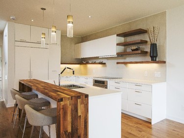 Architect Christopher Simmonds chose the finishings in the Lynwood, including a customized walnut eating bar and floating walnut shelves in kitchen.