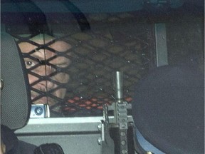 Basil Borutski leaves in a police vehicle after appearing at the courthouse in Pembroke.