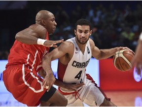 Canada's Phil Scrubb drives against a Panamanian forward during action in the FIBA tournament in Mexico City.