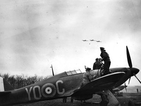 A Hurricane belonging to No. 1 Squadron, Royal Canadian Air Force is re-armed while a section flies over the airfield. The Hurricane is marked with the unit’s designator: “YO”. From the photo album of Flying Officer R.W.G. Norris, from Saskatoon, Saskatchewan, who served with No. 1 Squadron during the Battle of Britain. PHOTO: With the permission of the National Air Force Museum of Canada.