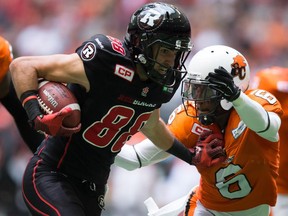 Ottawa Redblacks' Brad Sinopoli, left, fights off B.C. Lions' T.J. Lee (6) as he carries the ball after making a reception during the first half of a CFL football game in Vancouver, B.C., on Sunday, September 13, 2015.