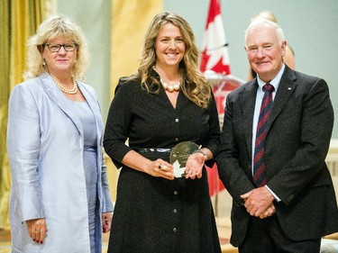 Caitlyn Rochon of Veterans Affairs Canada receives the Public Service Award of Excellence for Large-Scale Special Event of Project on behalf of the team the organized the D-Day and Battle of Normandy 2014 Team from Janice Charette, clerk of the privy council, left, and David Johnston, Governor General of Canada, right, at Rideau Hall Wednesday September 16, 2015. (Darren Brown/Ottawa Citizen) - Assignment 121627