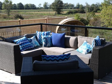 In the backyard, a generous cedar deck means there’s room for both an eating area and a lounge area, while in the back corner, a barrel sauna beckons.