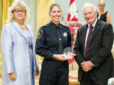 Christine Fournier of Canada Border Services Agency, center, receives the Public Service Award of Excellence for Exemplary Contribution Under Extraordinary Circumstances on behalf of the Ebola Response Team from Janice Charette, clerk of the privy council, left, and David Johnston, Governor General of Canada, right, at Rideau Hall Wednesday September 16, 2015. (Darren Brown/Ottawa Citizen) - Assignment 121627