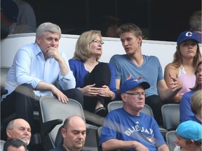 TORONTO, CANADA - AUGUST 31: Stephen Harper watches the Toronto Blue Jays MLB game against the Cleveland Indians with his wife and son on August 31, 2015 at Rogers Centre in Toronto.