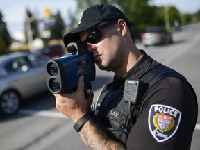 Const. Jon Hall look for drivers speeding in the school zone at Paddler way and Jeanne D'arc Boulevard as part of the back-to-school safety blitz.