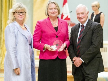 Dale Cindy Sharkey from Veterans Review and Appeal Board receives the Public Service Award of Excellence for Outstanding Career from Janice Charette, clerk of the privy council, left, and David Johnston, Governor General of Canada, right, at Rideau Hall Wednesday September 16, 2015. (Darren Brown/Ottawa Citizen) - Assignment 121627