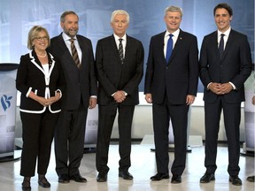 Green party Leader Elizabeth May, NDP Leader Tom Mulcair, Bloc Quebecois Leader Gilles Duceppe, Conservative Leader Stephen Harper, and Liberal Leader Justin Trudeau pose for photos before the French-language leaders' debate Thursday, September 24, 2015  in Montreal.