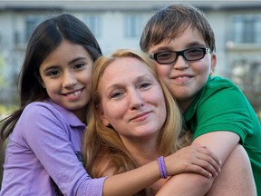 Ellen Francisco, seen here with her daughter Saffron and son Matteo, is a Canadian who lived in California for 25 years, adopted two American kids considered medically fragile, and returned to Canada about two years ago and filed for Canadian citizenship for her kids. Her son, Matteo, 11, is in need of heart surgery to correct a birth defect but doesn't have citizenship yet and as such doesn't have OHIP. Assignment - 121669 Photo taken at 16:56 on September 17. (Wayne Cuddington/ Ottawa Citizen)