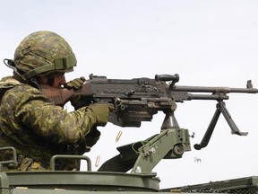 A Canadian Army reservist fires his machine-gun during exercises in 2009 at CFB Suffield, Alberta.