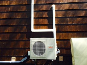 The external compressor of this ductless heat pump connects to wall-mounted delivery units inside the house. Systems like this both heat and cool.