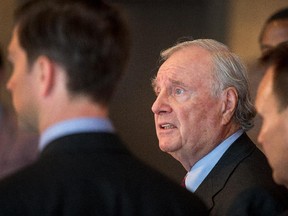 Gatineau area Liberals flank former Prime Minister Paul Martin as he talks to the media following a breakfast meeting on Wednesday morning at the Hotel Ramada du Casino.